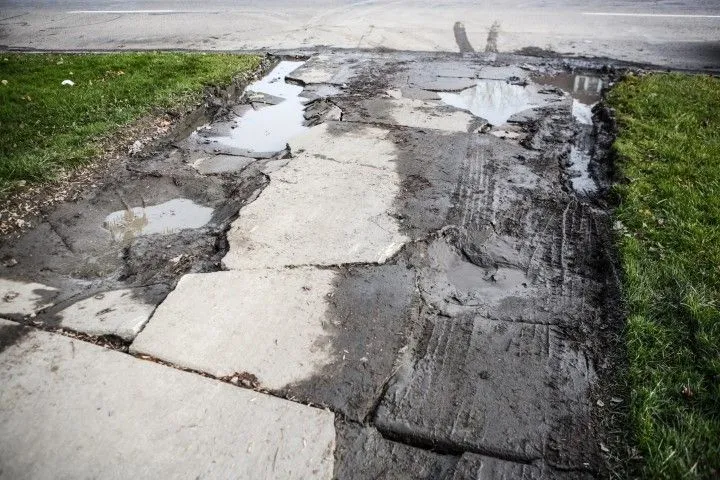 Severely cracked and damaged concrete driveway needing repair in Grandview, MO