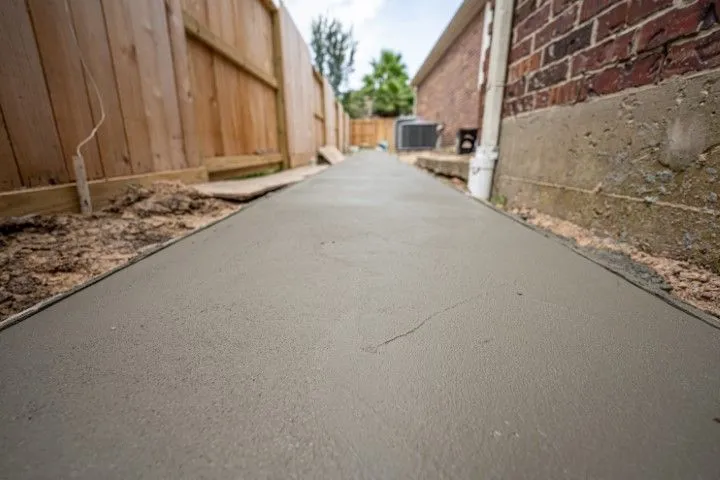 Narrow concrete pathway along side of brick building in Grandview, MO